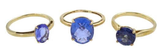 Three 9ct gold single stone blue stone set rings