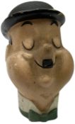 Mid-20th century composition bust of Oliver Hardy depicted smiling with eyes closed and wearing a to