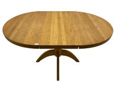 Solid light oak circular extending dining table