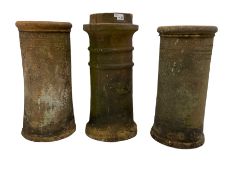 Three Victorian terracotta chimney pots with decorative banding