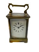 An early 20th century French timepiece carriage clock in a Corniche case with a white enamel dial