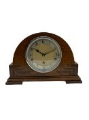 An English chiming mantle clock by Walker & Hall in an arched oak case with rosewood inlay