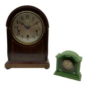 An early 20th century arch topped mahogany mantle clock with inlaid satinwood stringing on a moulded