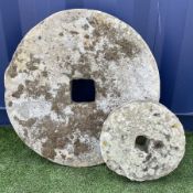 19th century weathered sandstone millstone and a smaller millstone