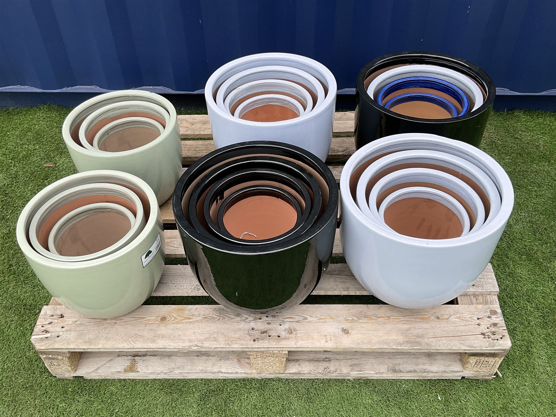 Quantity of circular glazed garden planters in various sizes and colours