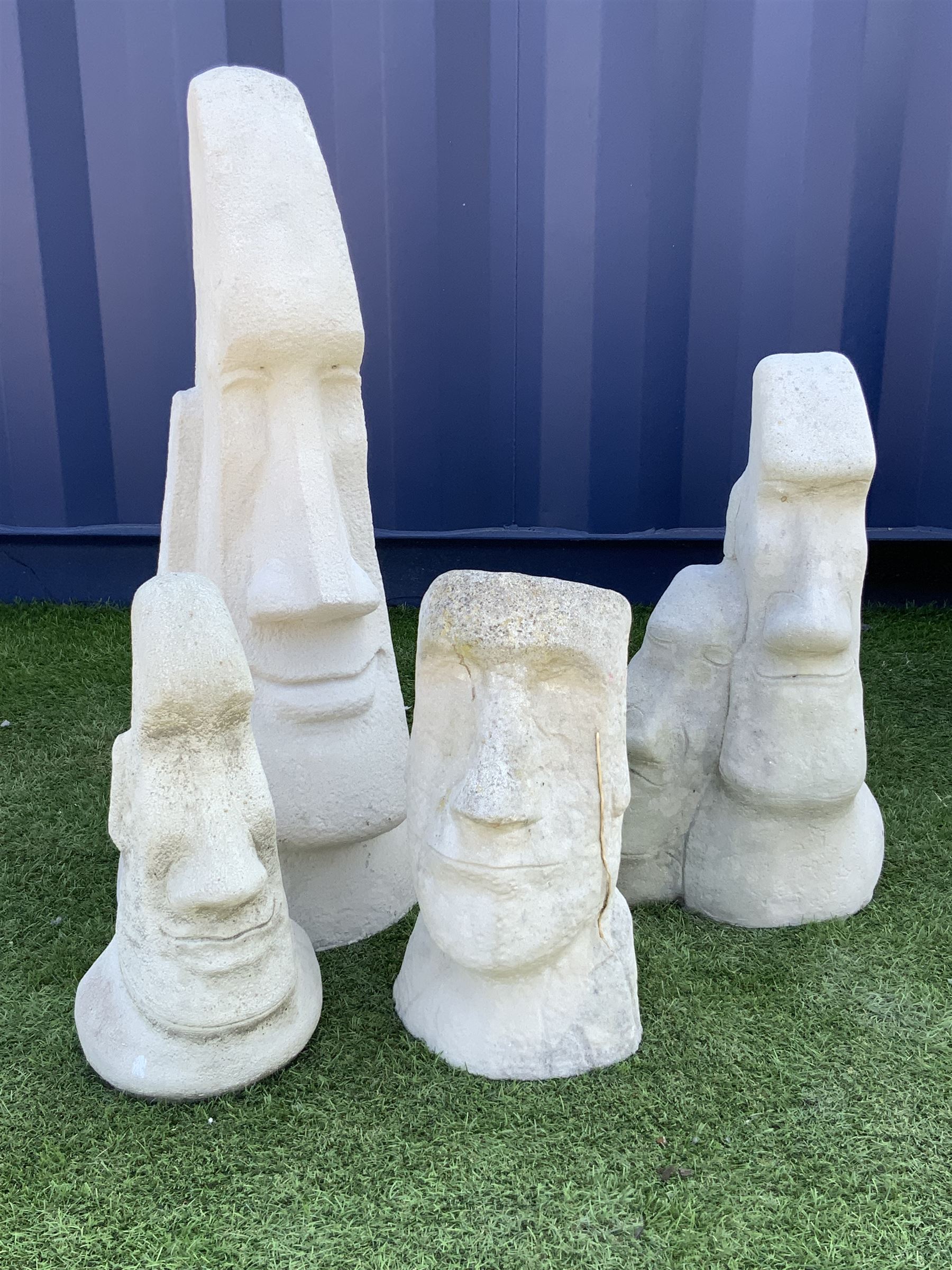 Collection of four composite stone Easter Island head statues