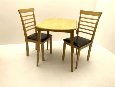 Circular light wood drop leaf dining table and two chairs