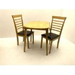 Circular light wood drop leaf dining table and two chairs