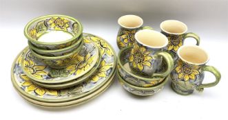 Dinner wares decorated with painted sunflower pattern