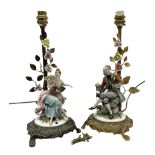 Two Capodimonte table lamps with seated lady and gentleman upon brass bases with floral decoration