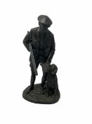 Bronzed figure of a man with a shotgun and a dog
