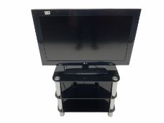 LG television on black glass stand