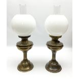 Two brassed oil lamps with glass shades and chimneys