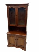 Mahogany bookcase on cupboard