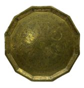 Eastern brass faceted tray with impressed script and scrolling decoration D48cm.