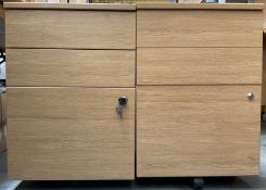 Two light oak effect three drawer pedestals on castors - THIS LOT IS TO BE COLLECTED BY APPOINTMENT