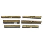 Six brass topped ebony levels, one with sliding cover 6" to 8" G+