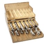 A set of 12 twist bits by various makers in wood case, plus VAT G+