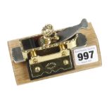 A recent miniature steel soled brass mitre plane 4" x 1" by ROGER SMEATON with decorative edges