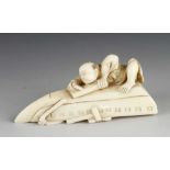 A 19c Japanese ivory okimono of a boat builder planing the bottom of his boat 3" x 1 1/2" with other