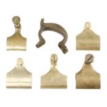 Five unfinished brass lever caps and an iron handle N