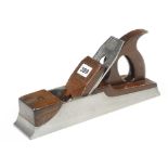 An iron panel plane 12 3/8" x 2 5/8" with mahogany handle and wedge behind iron lugs G