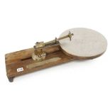 A rotary glass cutter by STARRAT & NEWTH on mahogany base with graduated brass rule G