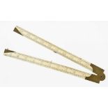 A 2' two fold ivory rule with bevel edges and unusual brass fittings, minor warp G+