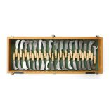 A craftsman made set of 34 miniature 4 1/4" billhooks with handles of hickory and red oak in display