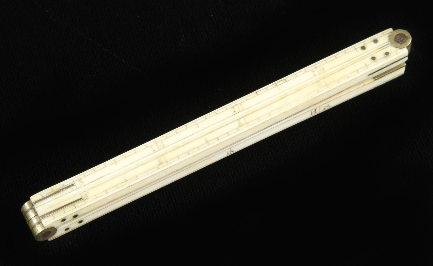 A slender, square section 18" four fold ivory rule reading right to left with Nails & H. Nails and