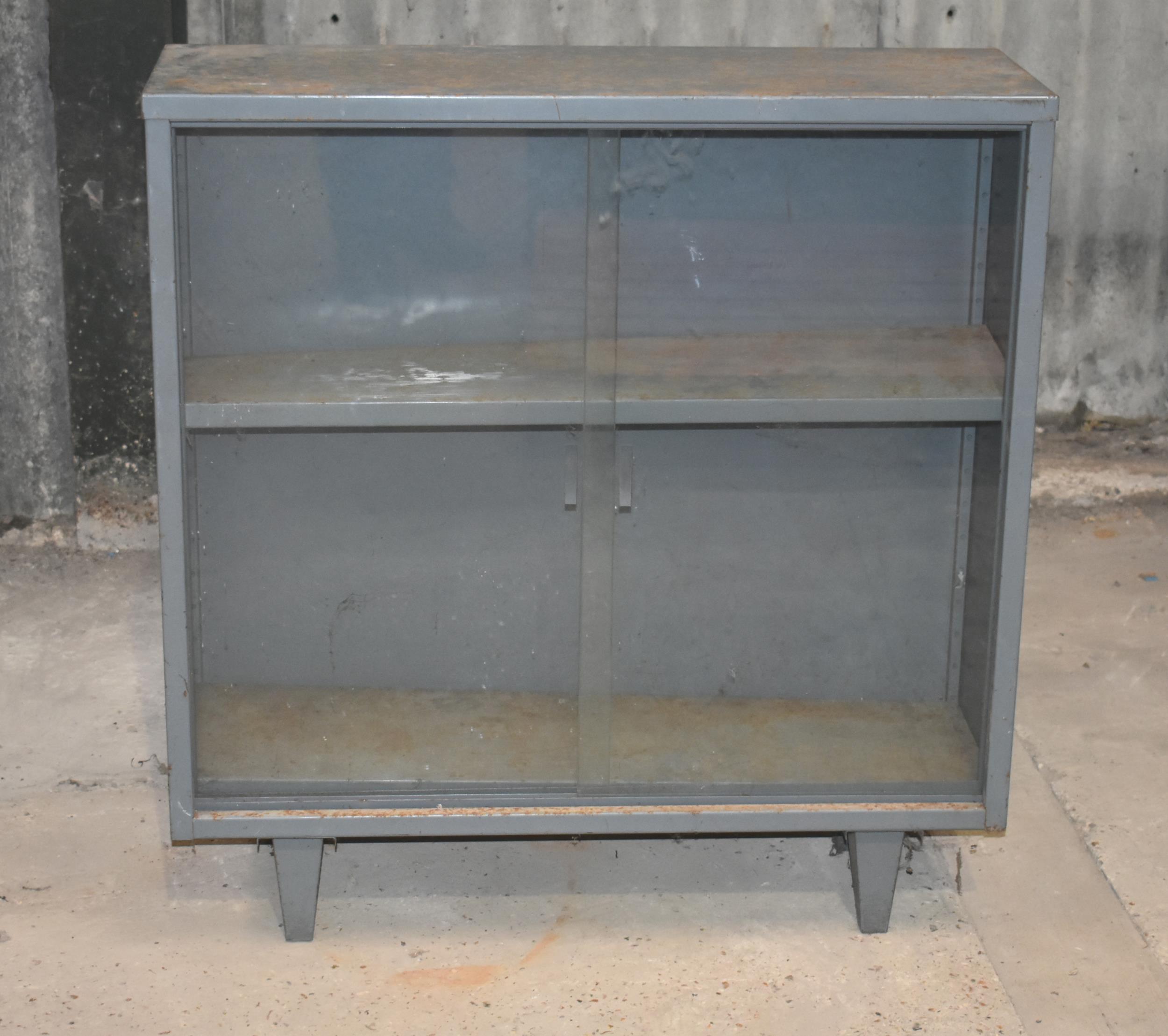 A glass front metal cupboard