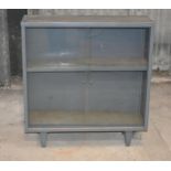 A glass front metal cupboard