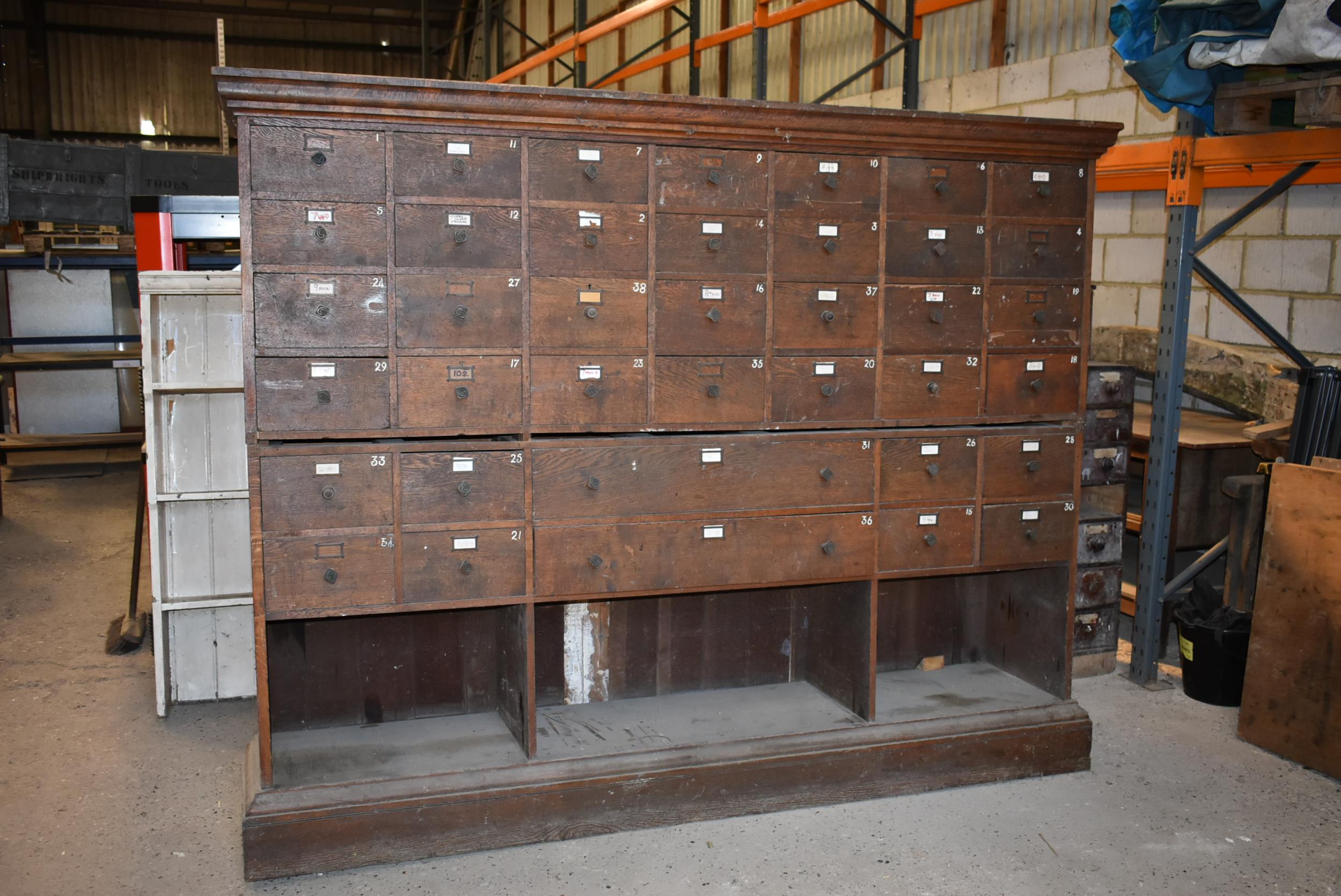 An impressive 42 drawer oak shop fittings 93" x 19" x 74" marked C.G. on the drawer knobs