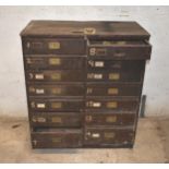 A wood multi-drawer chest with 14 drawers