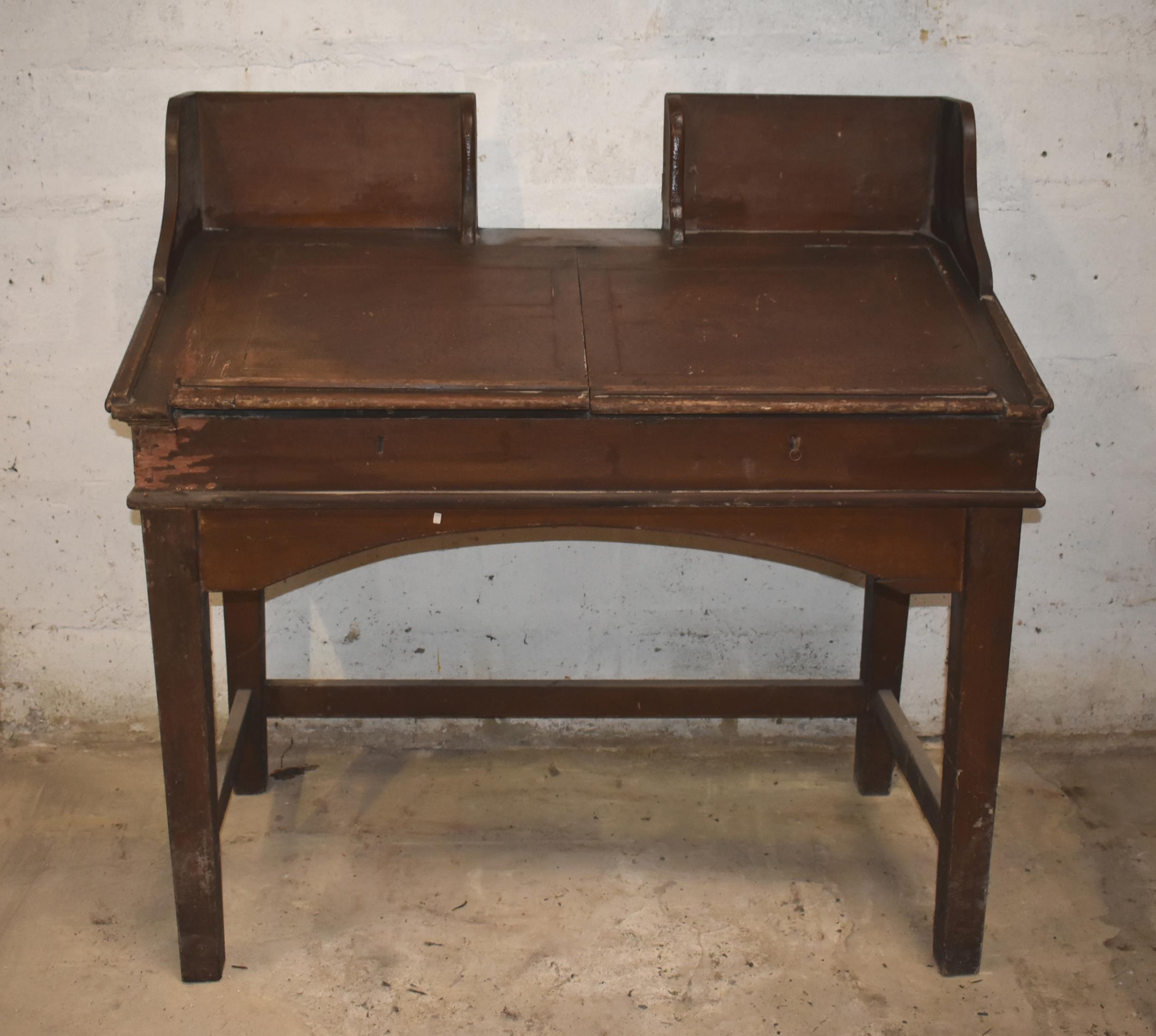 A clerk's antique desk with woodgrain finish