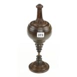 A decorative lignum and ebony plumb bob 13" high with screw top on matching stand G+