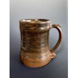 A Leach Pottery, St Ives standard ware pint mug. Height 12.5cm. Impressed studio seal.