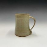 A Leach Pottery, St Ives standard ware celadon glaze pint mug. Height 12cm. Impressed studio seal.