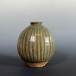 Katharine Pleydell-Bouverie (1895–1985) A fluted stoneware bottle vase with green glazeImpressed