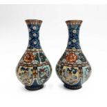 A pair of Japanese cloisonne vases, 19th century, with flowerheads and tendrils above a horizontal