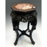 A Chinese carved hardwood jardiniere stand, 19th century, the top with octagonal pink marble