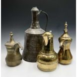 Two Saudi Arabian brass dallah pots, 19th century, heights 33cm and 26cm, an islamic brass jug,