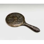 A Chinese silver hand mirror, 19th century, with circular bevelled plate, the handle and rear