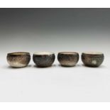 A set of four Burmese silver bowls, early 20th century, each with a single plain shaped cartouche