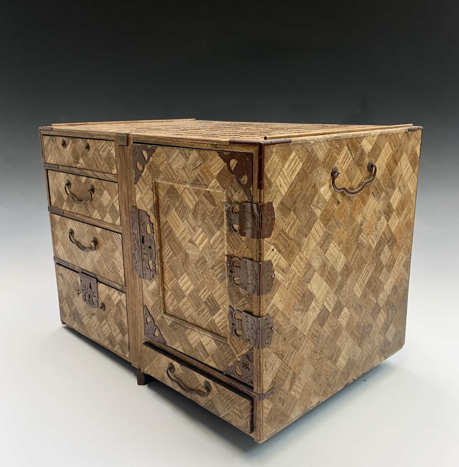 A Japanese parquetry jewellery cabinet, Meiji Period, with five drawers and a door opening to reveal