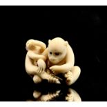 A Japanese ivory netsuke of a monkey with her young, by Hogan Rante, Meiji Period, signed, height