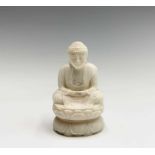 A Chinese carved ivory figure of a seated Buddha, 19th century, red character mark, height 6cm.