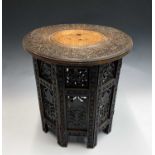 An Anglo-Indian carved hardwood folding occasional table, circa 1900, of small proportions, height