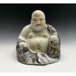 A large Chinese porcelain figure of a seated Buddah, 20th century, wearing a floral decorated robe