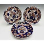 A pair of Chinese Imari porcelain plates, circa 1900, each with a central fluted panel enclosing a